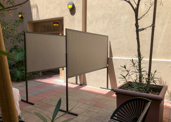 Four by eight foot poster boards outdoor perpendicular to wall in USC courtyard