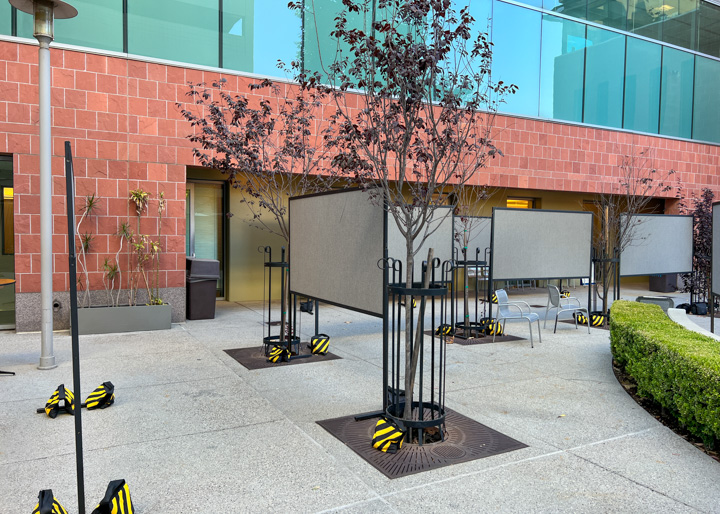 Four by eight foot double-sided poster boards set up outdoors with sandbags at Children's Hospital Los Angeles