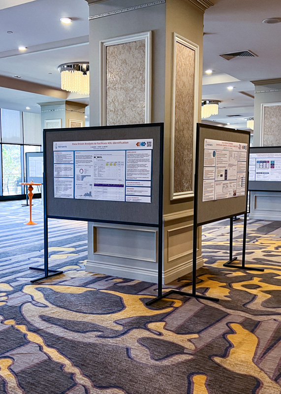 Printed research posters on pin boards in hallway around pillars